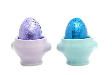 colorful easter eggs in cup over white background