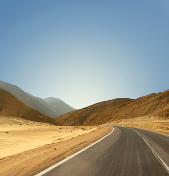 Image of a road on a desert background