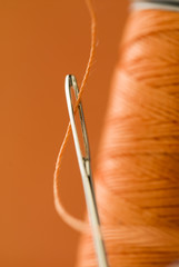 eye of a needle with thread close up