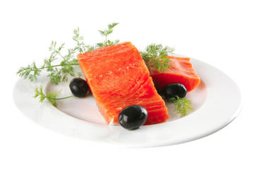 pink salmon on white plate with olives