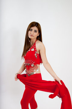 Pretty belly dancer dancing with a red scarf