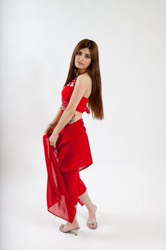 Pretty belly dancer dancing with a red scarf