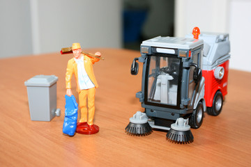 Scale models of a caretaker and a cleaner machine