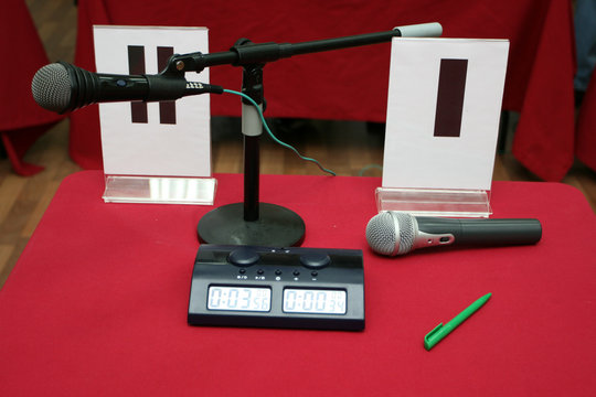 Bargaining table with chess-clock and a microphone