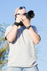 Young male photographer taking photographs