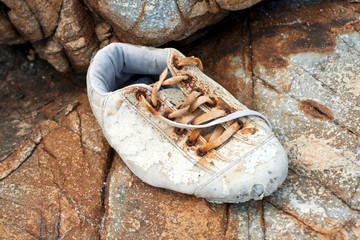 rotten shoes on beautiful rock