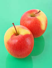 Juicy red apple on green