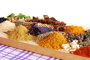 Different kinds of spices on wooden surface