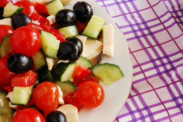 Fototapeta na wymiar Fresh salad dressed with olive oil, closeup..