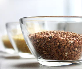 Fototapeten Three grains in glass bowls © Alexey Chernovalov