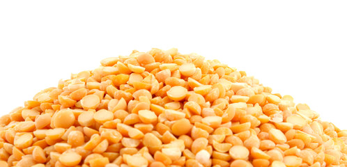 Pile of yellow split peas on white