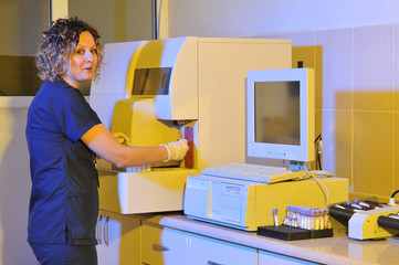 Female nurse working at dramatically lightened laboratory