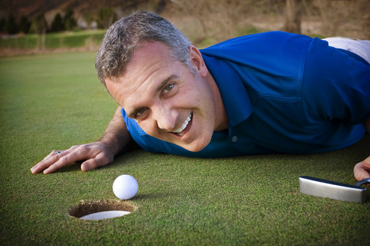 Male Golfer missing the putt