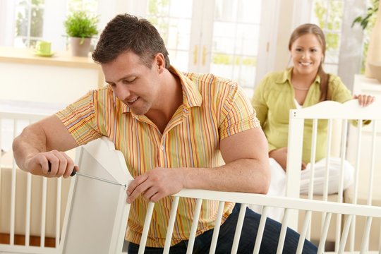 Dad Fixing Baby's Bed