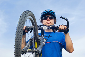 young bicyclist in helmet