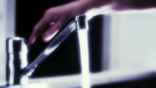 Filling glass of drinking water