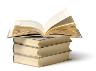 A pile of books, top one is open