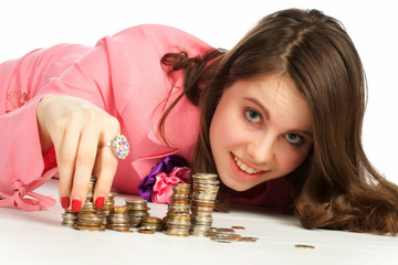 A woman touching stacks of coins