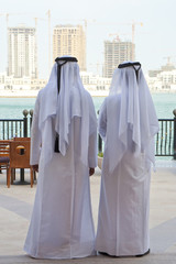 Fototapeta premium Two Anonymous Arab Men Looking At Construction of New Buidings