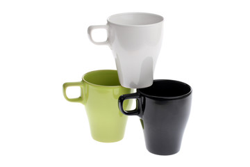 Three coffee cups one standing on top of two others