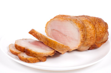 Chicken meat slices on a plate. A white background.