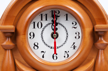 Wooden hours with a dial close up.