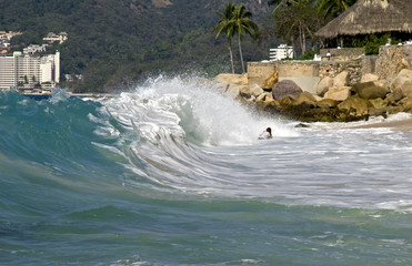 Bather catching high surf