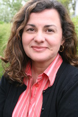 Woman, forty years old, brown curled hair, smiling