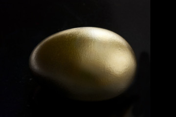 gold egg on dark background