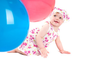 baby playing with colorful balloons
