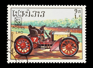 Fototapeta na wymiar Stempel poczty z Laosu featuring rocznika Daimler sportowy samochód