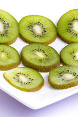 Fototapeta premium Kiwi slices on white plate
