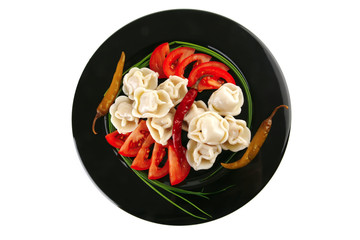 dumplings served with vegetables on black