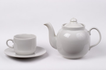 Little white tea cup and a kettle