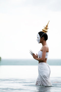 Mask woman playing thai traditional music instrument 2