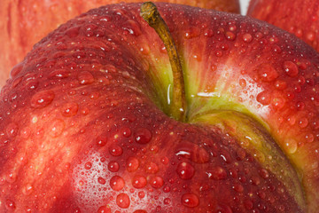 red apple in drops of water