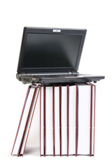 Laptop on a stack of books