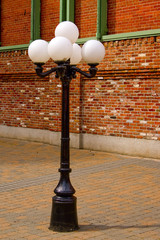 Antique Style Street Lamp in front of Brick Wall