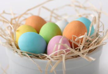 Colored eggs in a straw nest