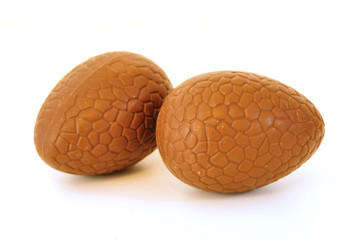 extreme close-up of chocolate egg, with white background