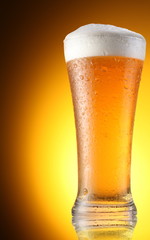 glass of beer on a brown background