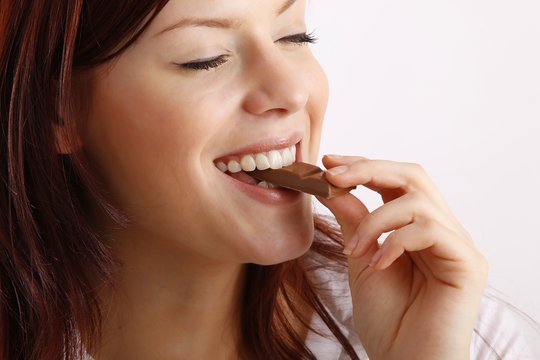 beautiful young woman with a bar of chocolate