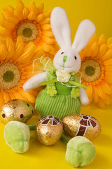 easter bunny sit on yellow floral background