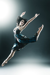 Stylish and young modern style dancer is jumping
