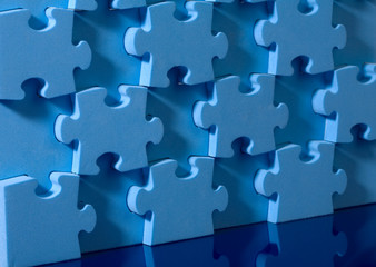 3D blue puzzle on blue background.