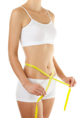 Woman measuring her slim body isolated on white