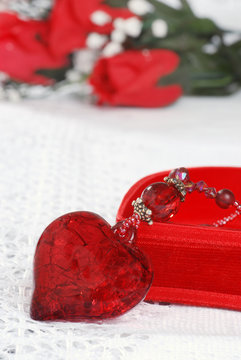 macro red heart jewelry leaning on box