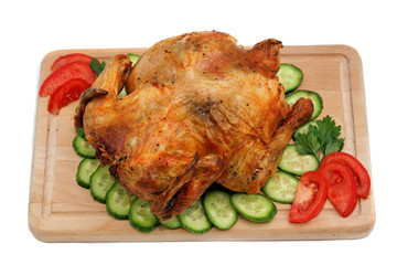 Roasted chicken on plate isolated on white