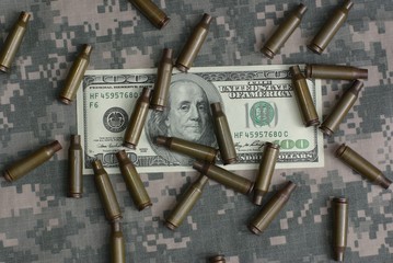 hundred dollars and shell on camouflage