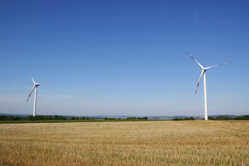 Wind turbines against blue sky